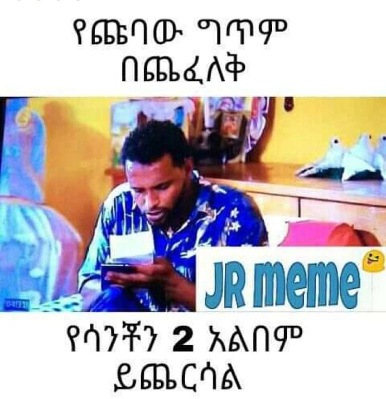 a man is sitting in front of a television screen